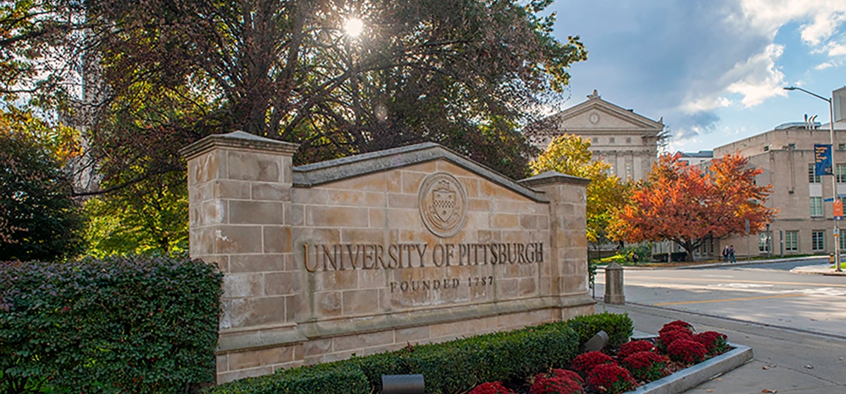 Stone wall with University seal and lettering reading University of Pittsburgh Founded 1787